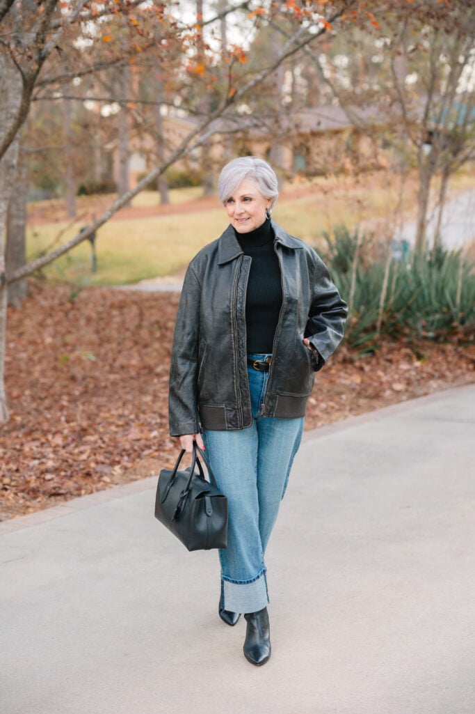 Medium wash straight leg jeans with neat cuff paired with pointy toe boots