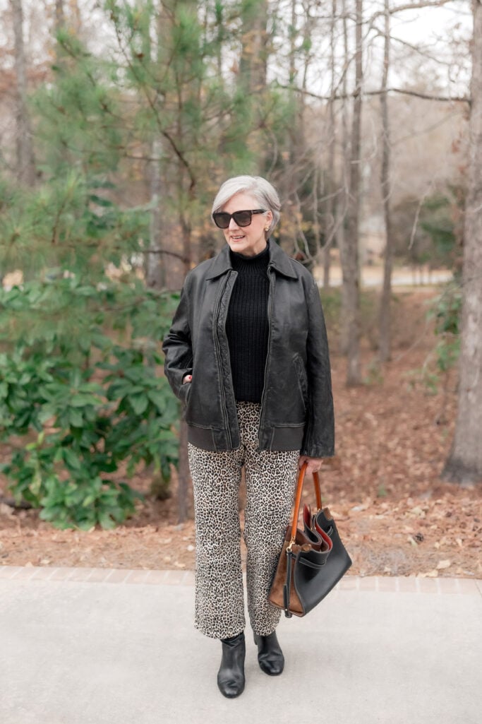 Straight leg leopard print jeans styled with simple black turtleneck and boots