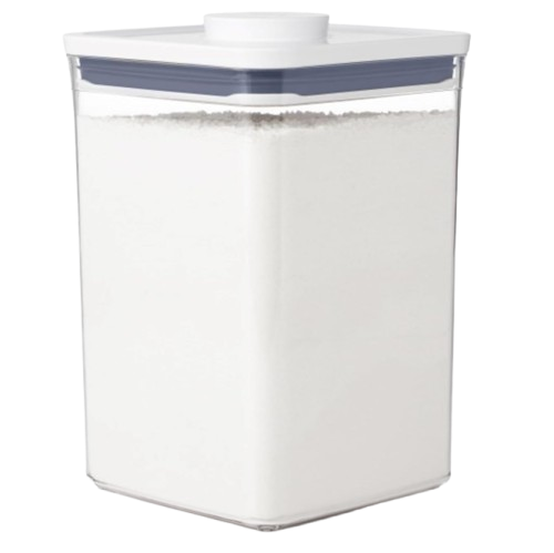 Clear OXO Good Grips POP food storage container filled with white flour, featuring an airtight lid with push-button seal for pantry organization.