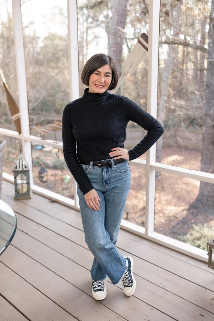 Kelly smiling in petite straight leg jeans and black Converse high tops - showing versatile straight leg fit for petites on screened porch