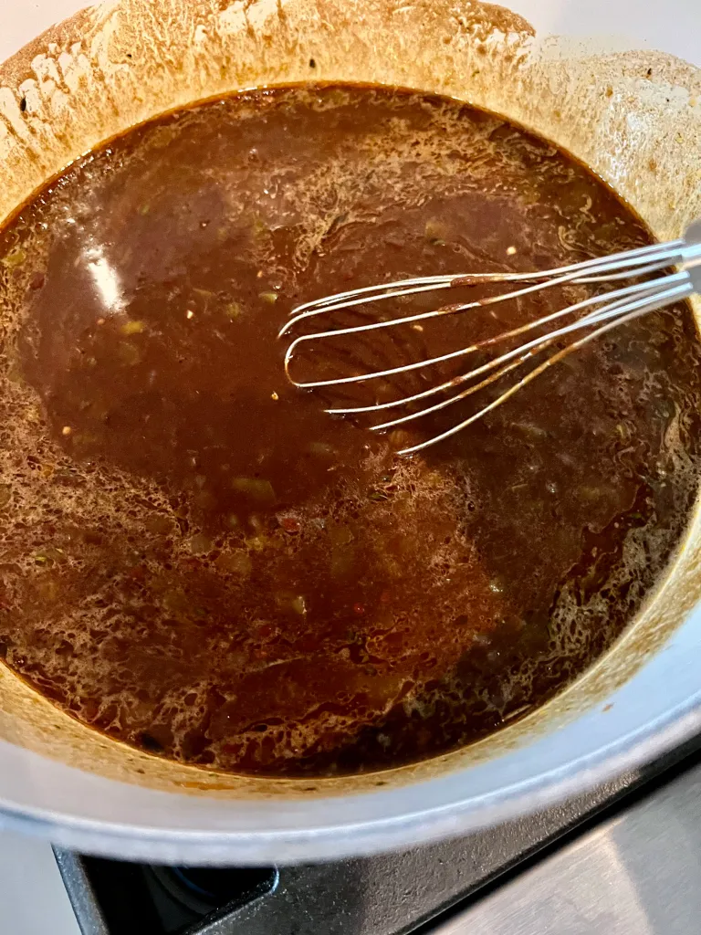 Gumbo simmering in the Dutch oven after the roux has been fully incorporated