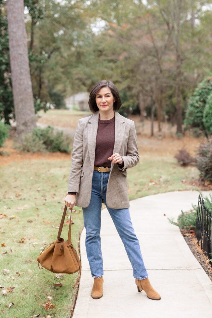 Kelly wearing a relaxed tan plaid blazer over a burgundy cashmere sweater with slim jeans and suede boots — balancing a longer blazer with slim bottoms