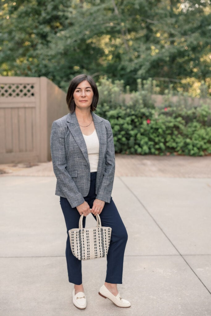 Kelly in a gray plaid blazer over a cream top with navy slim pants and cream loafers — polished petite workwear