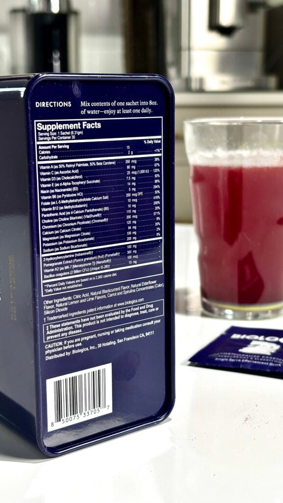 Pouring Biologica effervescent powder sachet into glass of water — dissolves in seconds with no pills