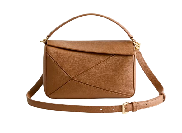 Italian leather patchwork crossbody bag in warm tan with geometric stitched detailing, structured flap closure, and adjustable strap with gold hardware.