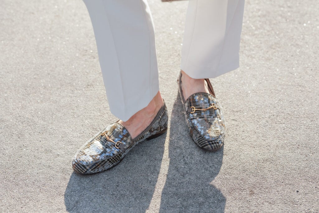 Close-up overhead shot of plaid sequin Loraine bit loafers with gold horsebit hardware worn with cream ankle pants — showing the subtle pattern mixing detail and ankle gap for petite proportions