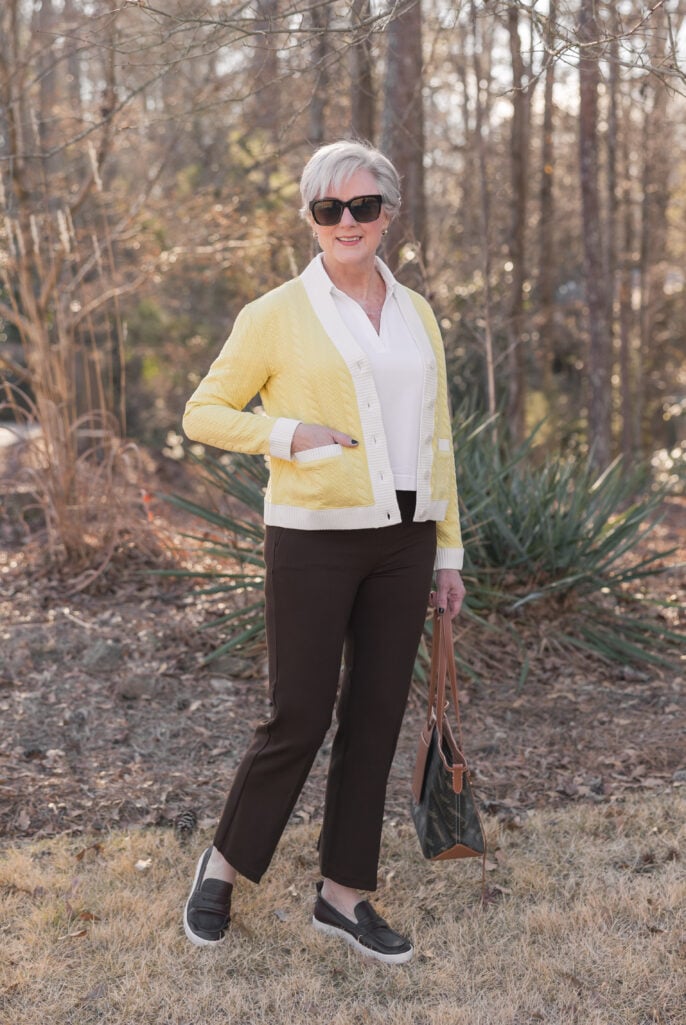 how to wear bold color after 50 — yellow cardigan with neutral trousers