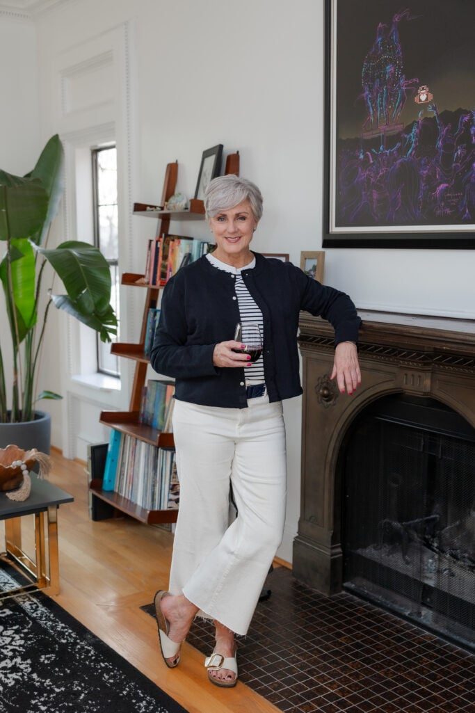 Beth wearing wide leg white jeans and jackie sweatshirt cardigan