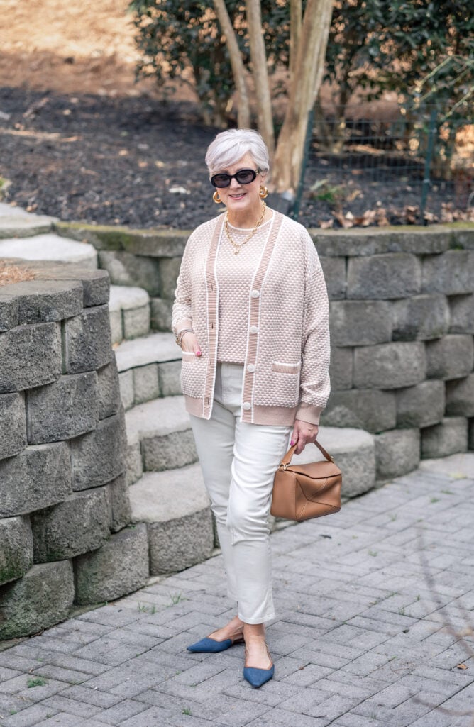Beth wearing a tonal knit cardigan and tank and high waist jeans