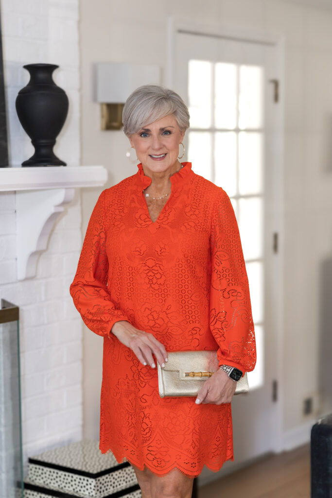 Beth in an orange Talbots lace shift dress with gold sandals — spring dresses for women over 50