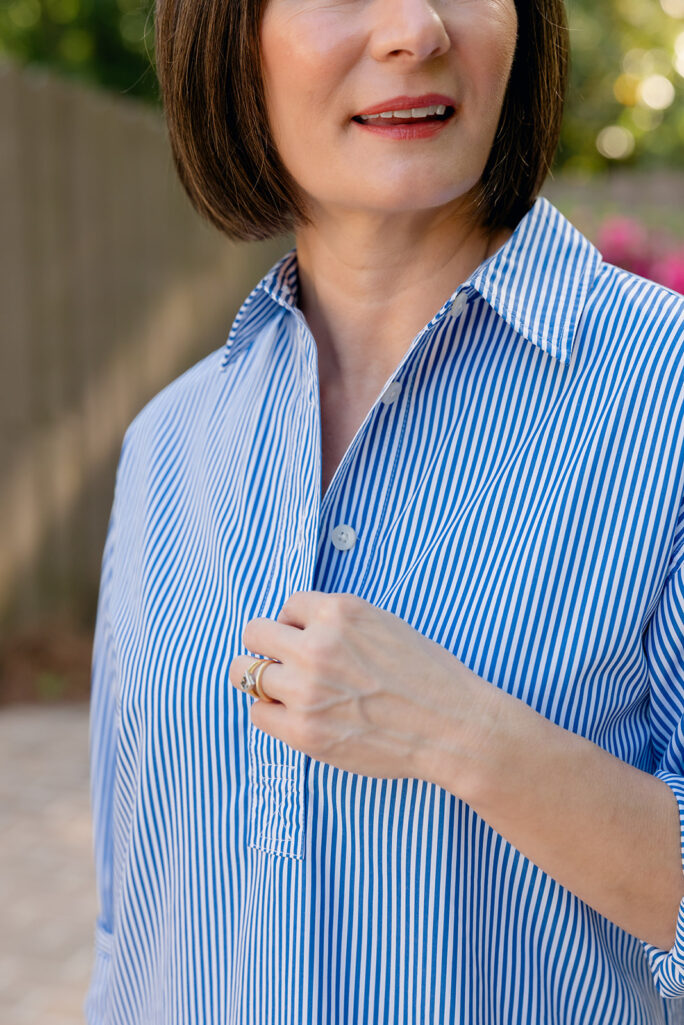 Close-up of blue and white striped broadcloth shirtdress collar and chest pocket detail with partial button placket — petite shirtdress fit details