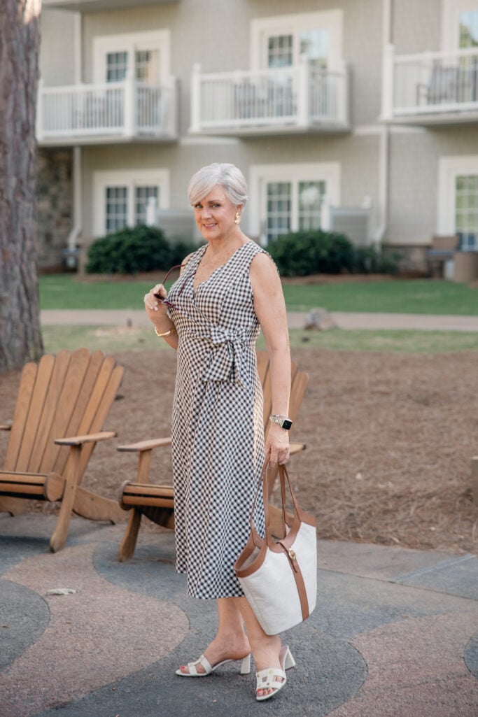 Gingham wrap dress styled with white linen button-down for resort wear over 50