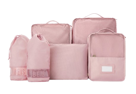 Blush pink packing cube set with mesh panels and drawstring bags, designed to organize clothing and travel essentials inside a suitcase.