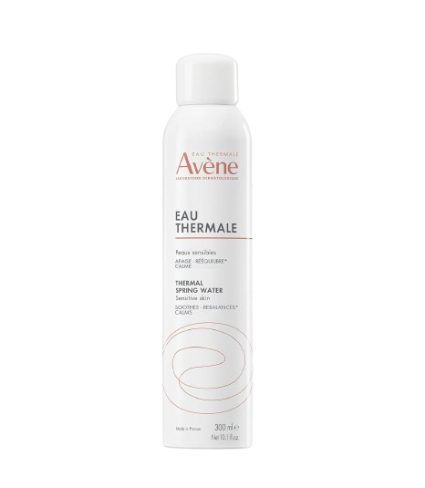 White aerosol can of Avène Thermal Spring Water facial mist, shown with water droplets to highlight its soothing, calming properties for sensitive skin.