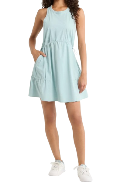 Zella Atlas Tiered Athletic Dress in light blue featuring sleeveless design, adjustable drawstring waist, tiered skirt, and side pockets styled with white sneakers for casual spring activewear.