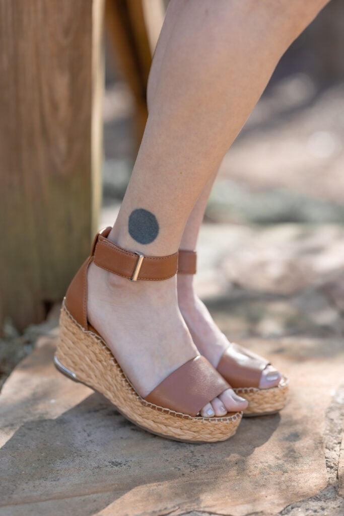 Close-up of Franco Sarto raffia espadrille wedge sandal with tan leather ankle strap and toe strap — neutral spring sandal for petite outfit styling