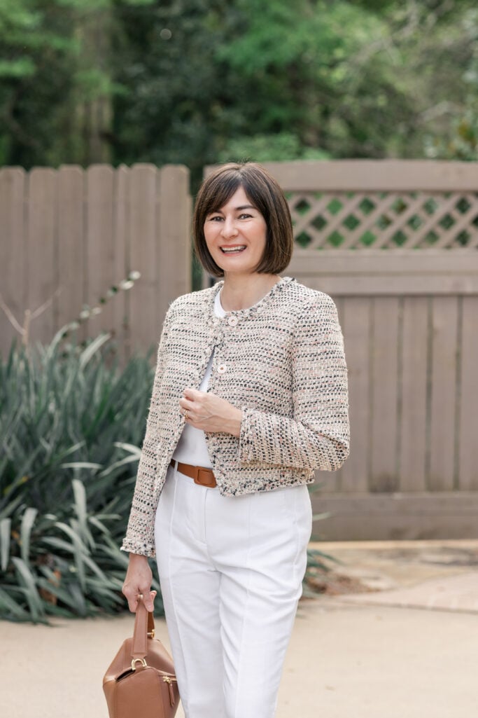 Kelly smiling in cropped Italian tweed jacket with white linen straight-leg trousers and cognac accessories — petite lady jacket spring styling
