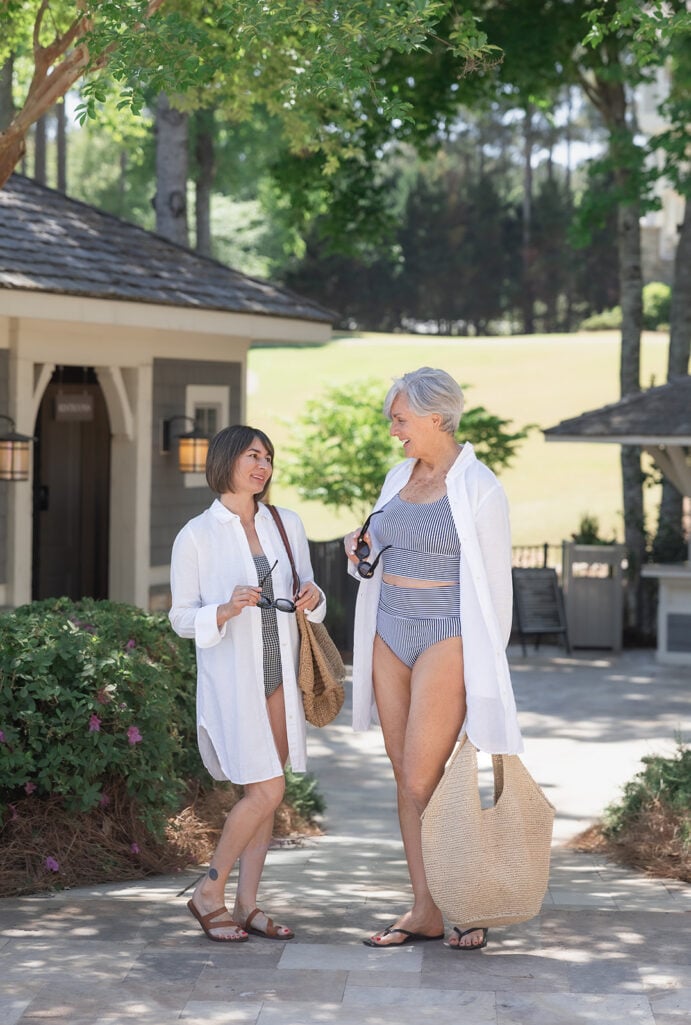 Kelly and Beth at a resort wearing swimsuits and white linen cover-ups — petite swimwear for women over 50