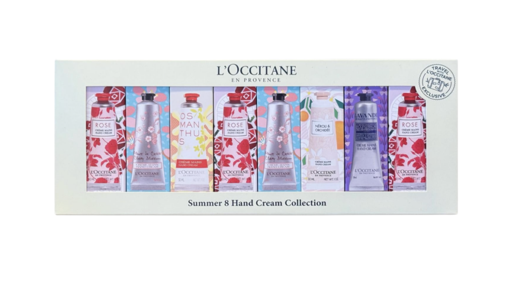 L'Occitane Summer 8 Hand Cream Collection shown in a pale mint gift box featuring eight mini tubes of hand cream in coordinating floral packaging — Rose, Cherry Blossom, Osmanthus, Néroli & Orchidée, and Lavender — with a "Travel with L'Occitane" exclusive seal in the corner, photographed on a white background — a beautifully giftable Mother's Day beauty gift available on Amazon for women over 50.
