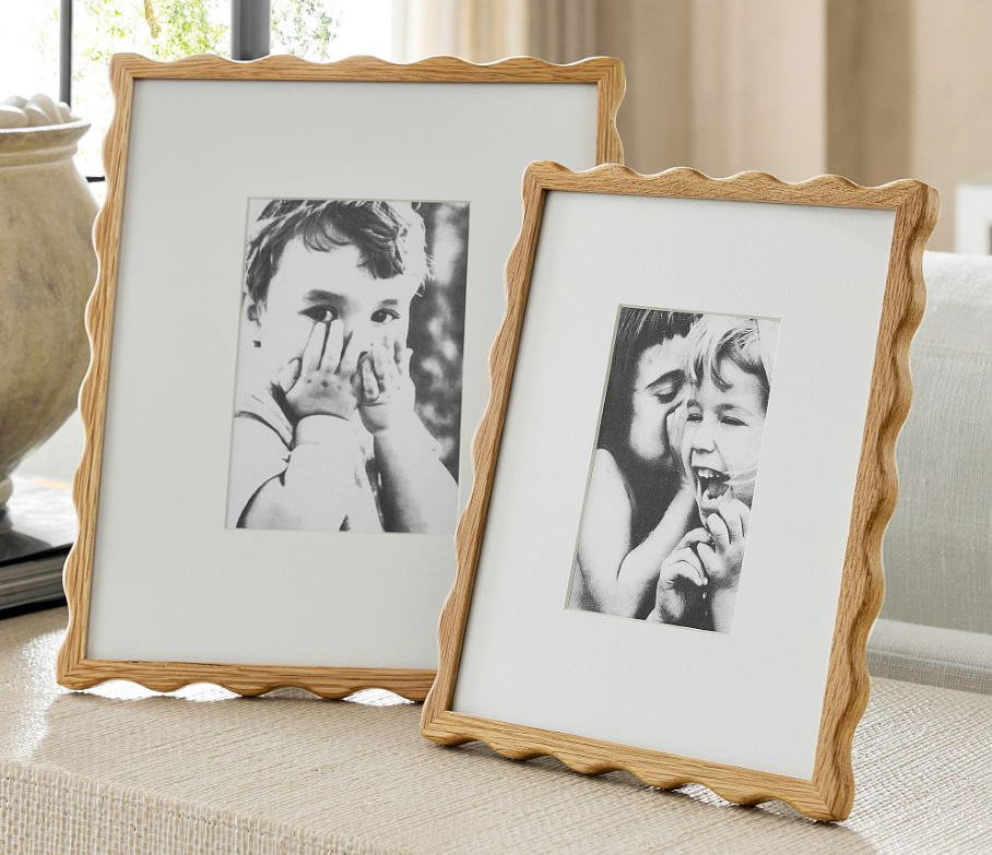 A softly scalloped wood frame that instantly elevates everyday photos into something special.