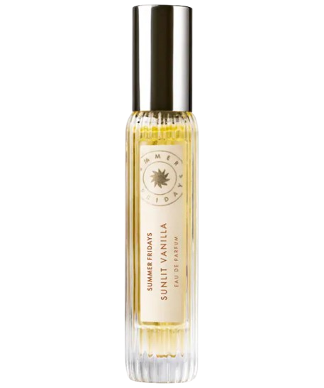 Summer Fridays Sunlit Vanilla Eau de Parfum travel spray with clear fluted glass bottle, pale golden liquid, and metallic cap, warm gourmand fragrance with notes of vanilla, caramel, and bergamot.