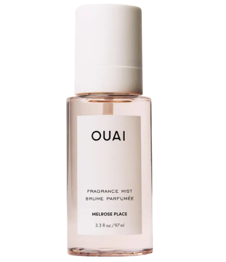 OUAI Melrose Place hair and body mist in a clear blush-toned bottle with white cap and label, light floral fragrance with notes of rose, champagne, and bergamot.
