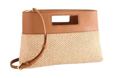 Rectangular raffia clutch bag with woven natural straw body, tan leather trim, cutout handle detail, zip-top closure, and removable crossbody strap.
