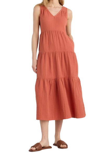 Terracotta gauze maxi dress with tiered silhouette, sleeveless V-neck design, side pockets, and relaxed fit styled with brown slide sandals.