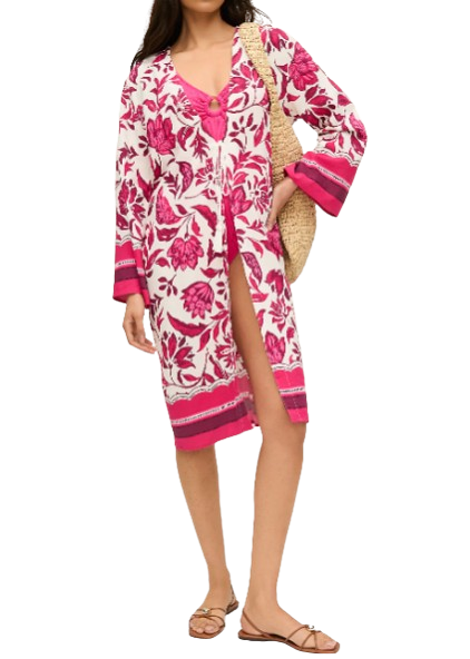 Pink and white floral beach kimono cover-up with tassel ties, contrast border trim, and flowy sleeves paired with metallic sandals and a woven tote.