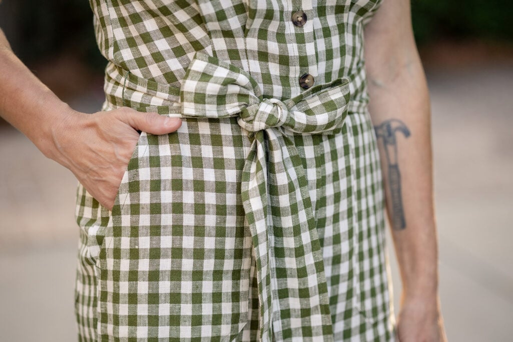 Close-up of self-tie waist belt on olive gingham linen Boden Kay playsuit — petite romper waist definition