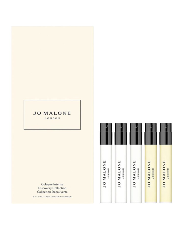 Jo Malone London Cologne Intense Discovery Collection shown with its cream-colored signature box and five mini 1.5 mL spray vials with black caps standing in a row beside the box on a white background — a giftable fragrance discovery set and Mother's Day beauty gift available on Amazon for women over 50.