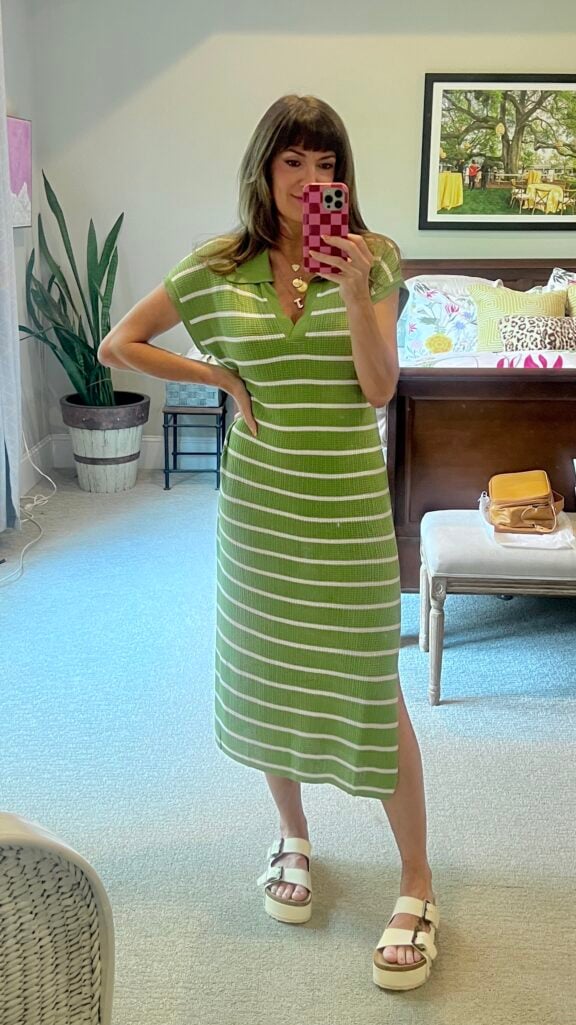 Full-length mirror selfie of a woman wearing a green and white striped short-sleeve sweater knit midi dress with a side slit and collared V-neck, paired with white platform buckle sandals