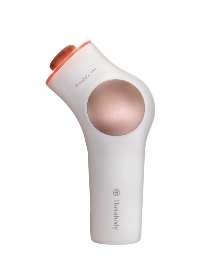 Therabody TheraFace PRO facial massage and skincare device in white with rose-gold accents and a coral red LED ring at the top, shown standing upright on a white background — a high-end beauty tech splurge Mother's Day gift available on Amazon for women over 50.