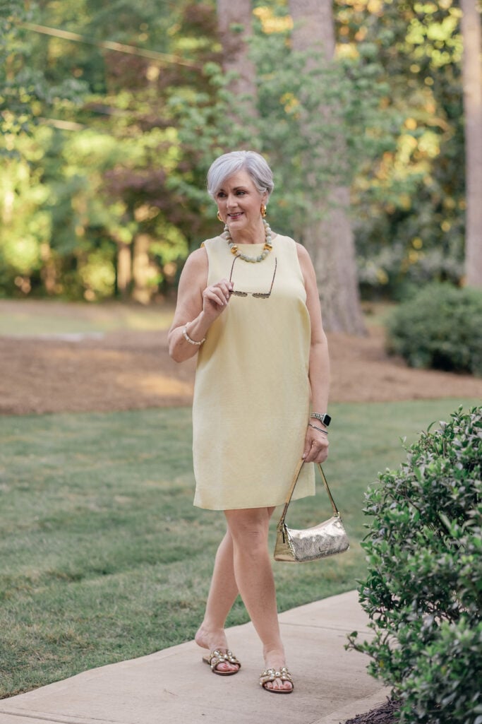 An over 50 woman wearing an Ann Taylor linen blend shift dress