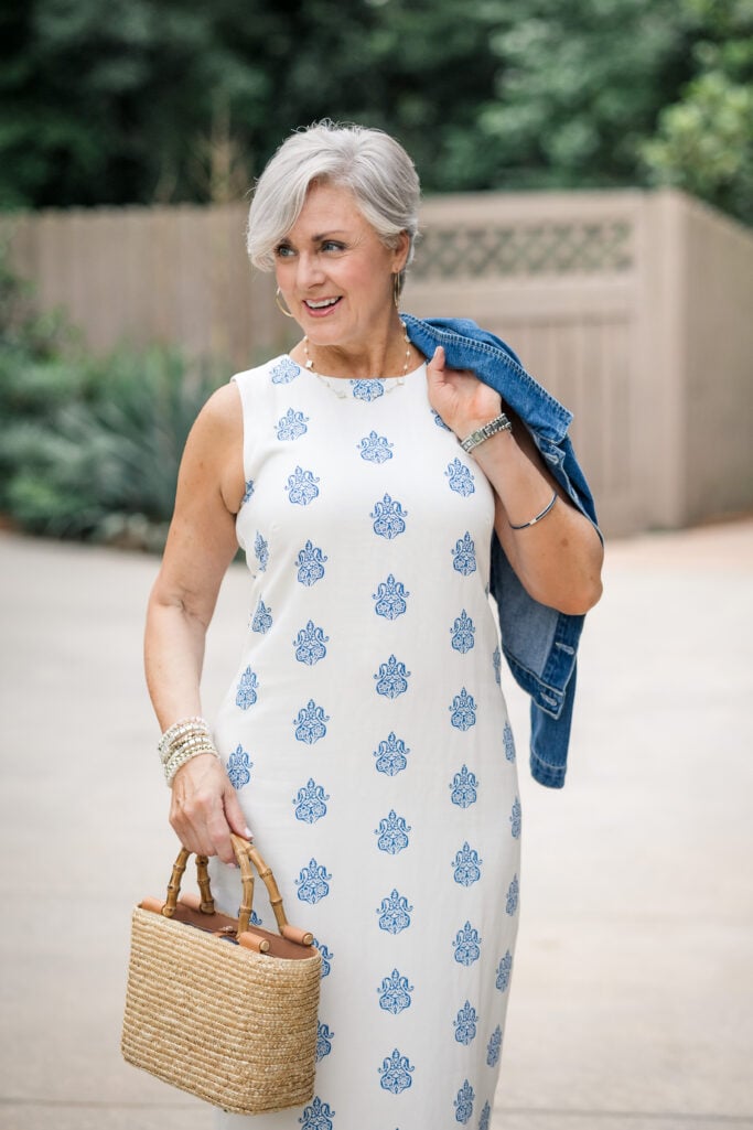Blue floral midi dress layered with a cropped denim jacket for polished summer style over 50.
