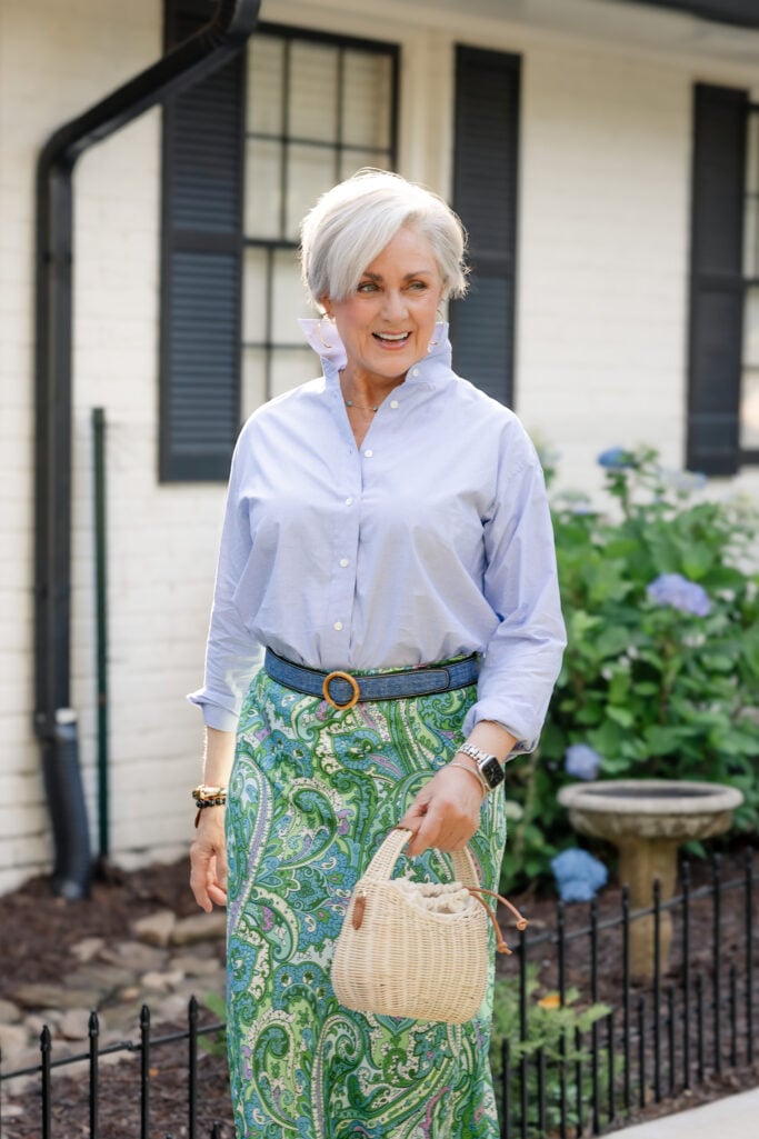 Beth in a blue J.McLaughlin shirt with popped collar and green paisley skirt for a weekend apartment lease signing