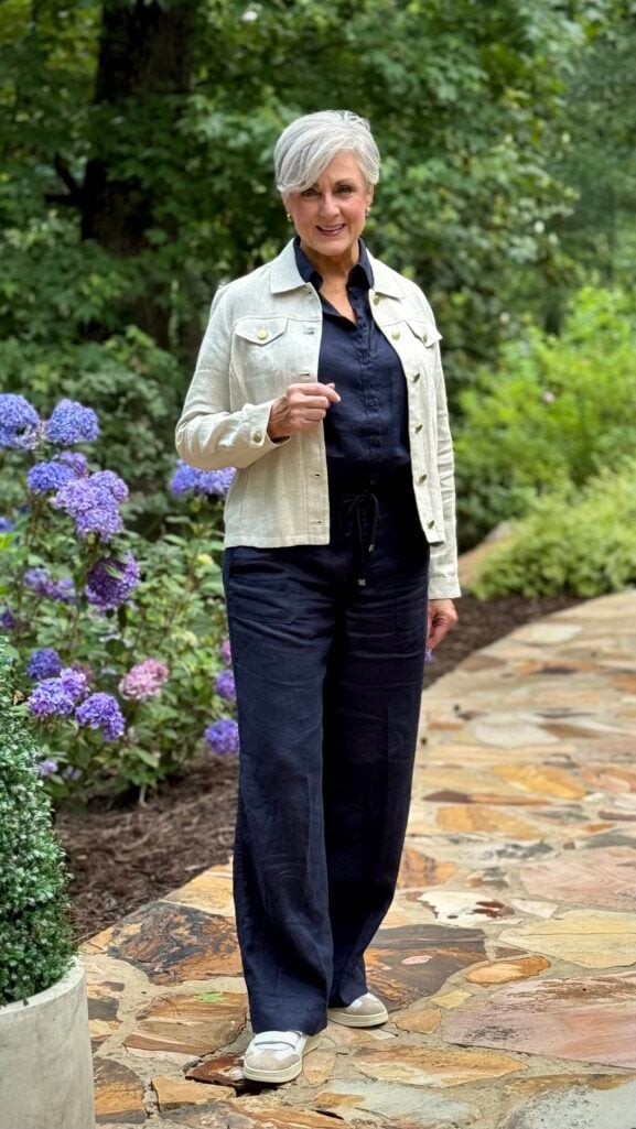Flax linen jacket, navy linen shirt, and navy linen pants with white sneakers — a polished airport outfit after 50