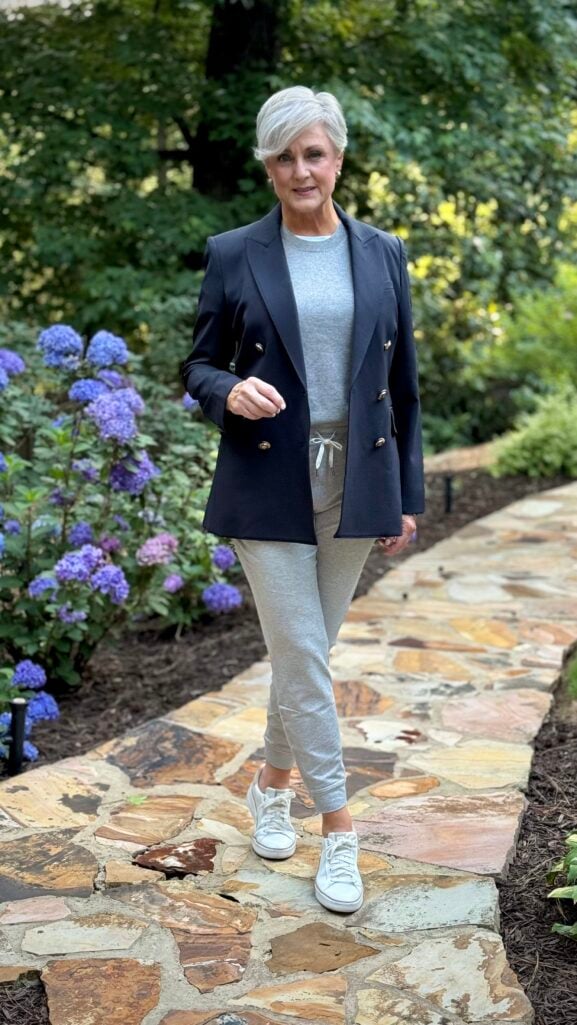 Gray joggers, gray tee, and a navy blazer — joggers made polished for travel after 50