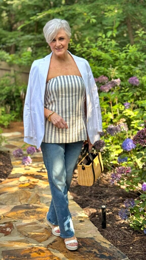 Linen-blend strapless top layered under a blazer with denim