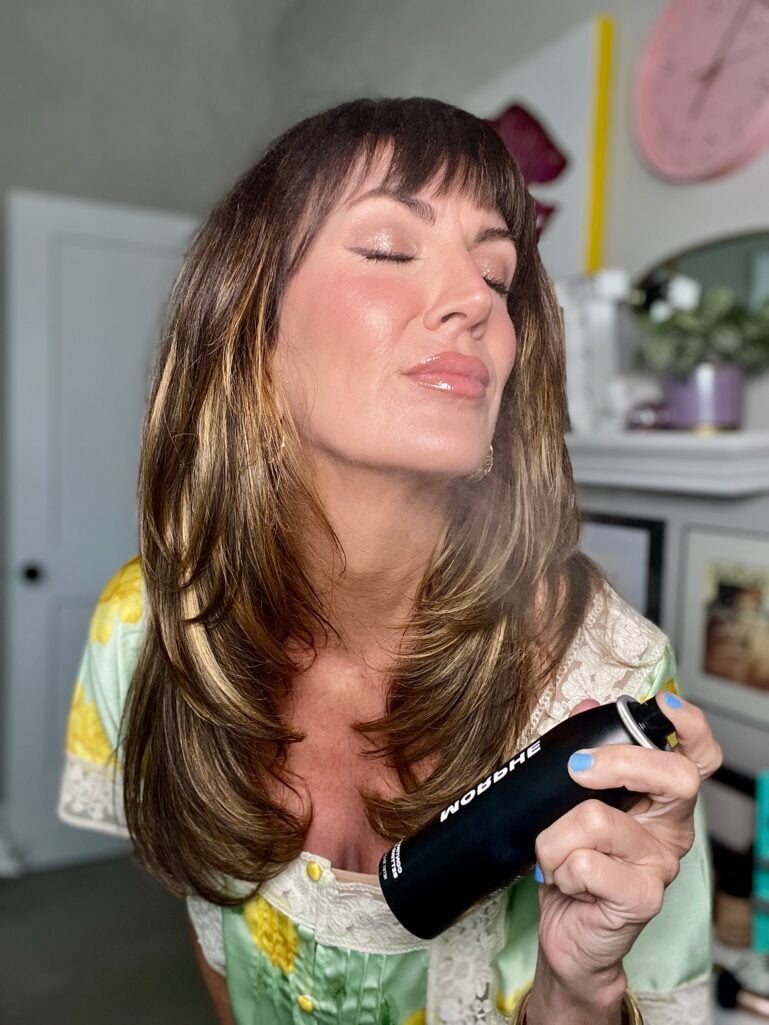 MAC Fix+ setting spray being misted in a criss-cross motion over finished makeup