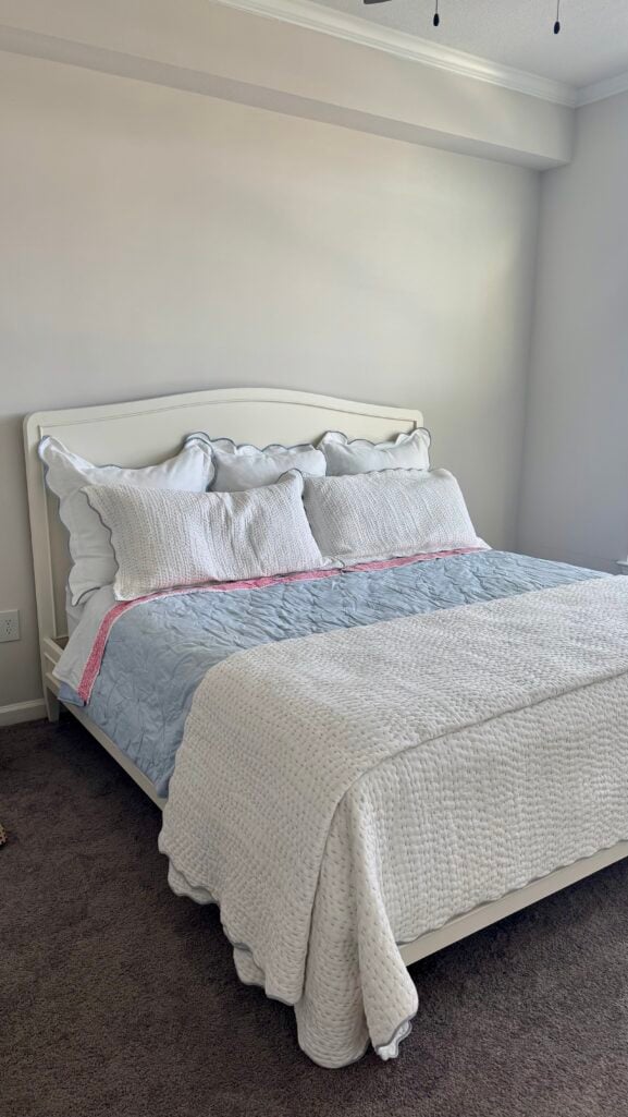 Tanner platform bed styled with a scalloped quilt, quilted sham, and scalloped euro sham in Beth's Atlanta apartment bedroom