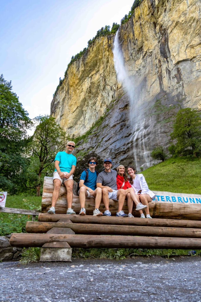 family of five posing at a waterfall in Switzerland
