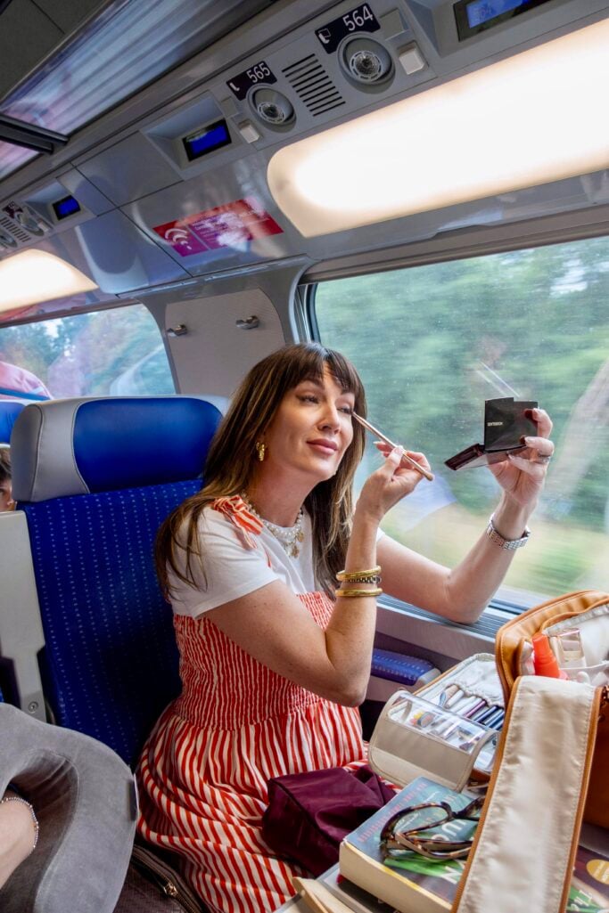 makeup artist applying makeup on the Eurostar train to Paris
