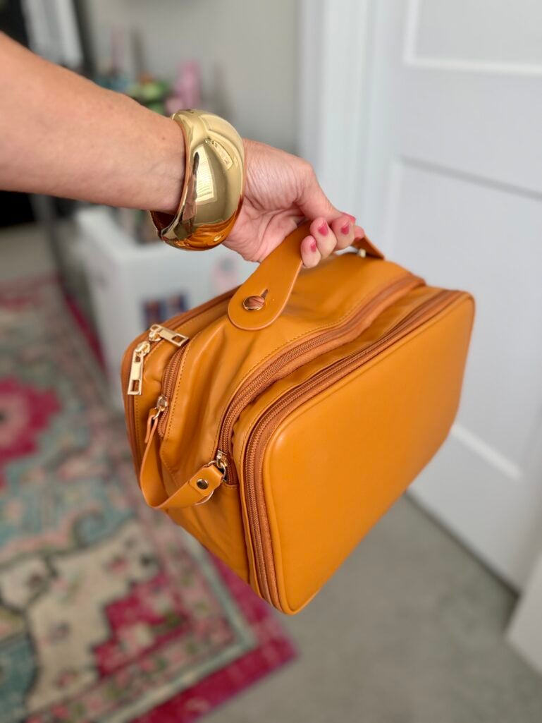 travel makeup bag essentials organized in a large-capacity cosmetic case