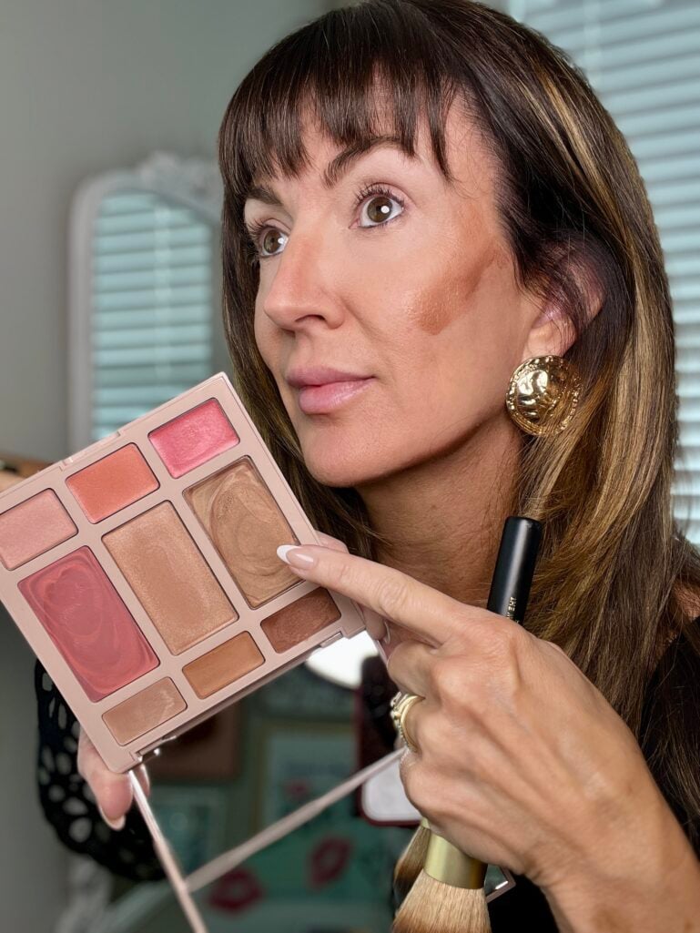 Pointing at the cream blush and highlighter shades in the Laura Geller palette