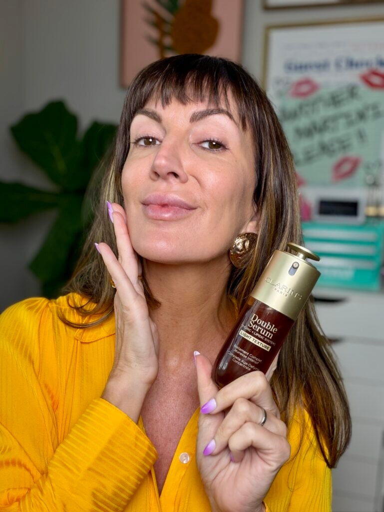 Makeup artist holding Clarins Double Serum anti-aging set from the Nordstrom Anniversary Sale