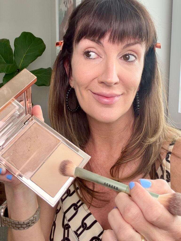 Setting under-eye concealer with pressed powder.