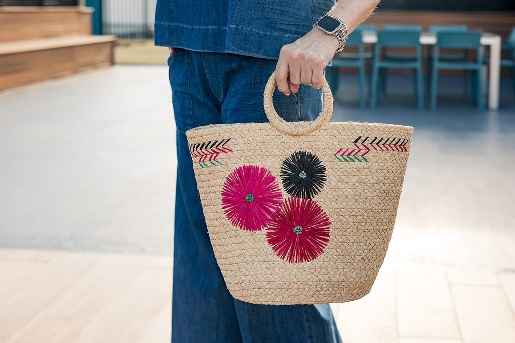 Embroidered floral straw handbag with a denim outfit