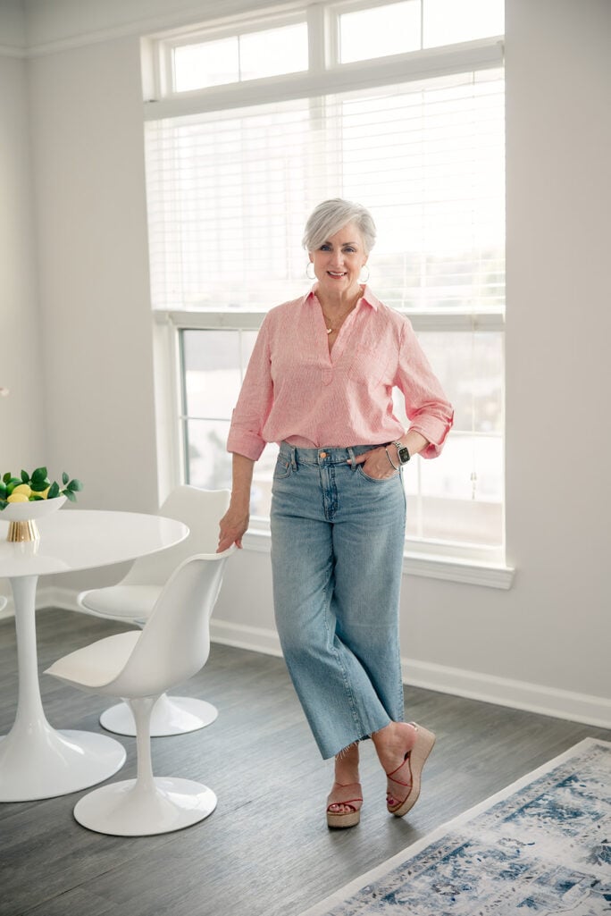 Woman wearing a striped popover top with wide leg cropped jeans and espadrille wedges