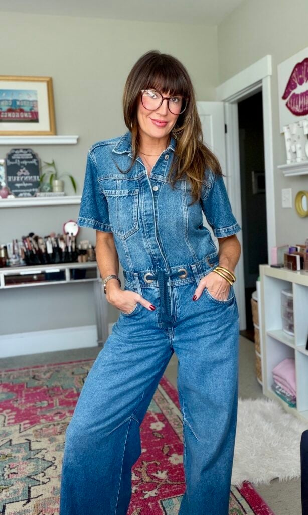 Jennifer in a denim jumpsuit styling beauty products for women over 50